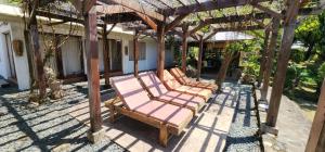a group of chairs sitting under a pergola at The Amazing Villa in Anepahan