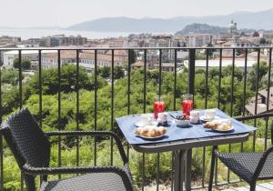 a table with food and drinks on a balcony at Stella Maggiore in Verbania