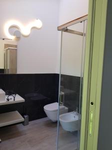 a bathroom with a toilet and a glass shower at Stella Maggiore in Verbania +66 photos