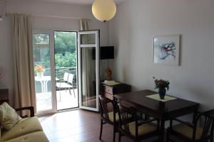 a living room with a dining room table and a table and chairs at Art.Villa.Nike in Koinyra