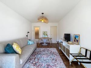 a living room with a couch and a table at Hello Menton in Menton