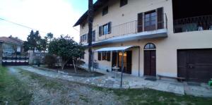 a large white building with a porch and a door at Ca' melindetta in Recetto