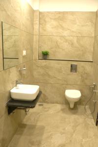 a bathroom with a sink and a toilet at Samyak Stay in Ujjain