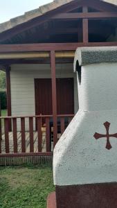 a house with a porch with a railing at Le chalet Paradis in Estang