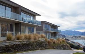a building on a hill with a view of the water at Goldrush # 2 in Queenstown