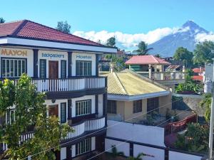 a view of a city with a mountain in the background at Mayon Backpackers Hostel in Legazpi