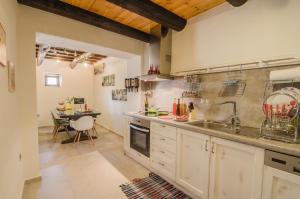 a large kitchen with a sink and a table at Angelos House Spa & Hammam in Arkhondikí