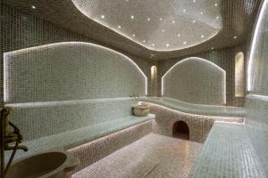 a bathroom with a bath tub and a sink at Marhaba Hotel & Spa in Tashkent