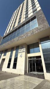 a tall building with a sign on the front of it at فندق العلاء 4 in Al Masfalah