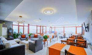 a restaurant with tables and chairs and windows at Naila Hotel in Istanbul