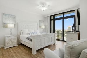 a white bedroom with a bed and a balcony at The Oasis at Orange Beach 1611 (Phoenix West II) in Orange Beach +85 photos