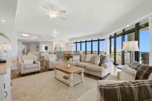 a living room with couches and a table at The Oasis at Orange Beach 1611 (Phoenix West II) in Orange Beach