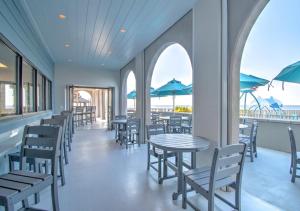 a dining room with tables and chairs and blue umbrellas at The Oasis at Orange Beach 1611 (Phoenix West II) in Orange Beach