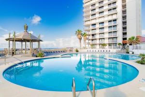 a large swimming pool in front of a building at Summer House 1501B in Orange Beach