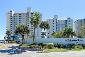 a building with palm trees in front of a street at Summer House 1501B in Orange Beach
