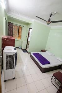a room with a bed and a fan in it at hotel bhagwati patel bright in Indore