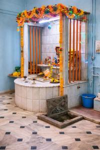a shower in a room with an entrance with an altar at hotel bhagwati patel bright in Indore