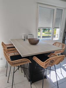 a kitchen with a table with chairs and a window at Cozy Home in Roussillon en Isere