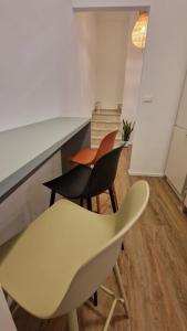 a kitchen with two chairs and a counter at House 100 meters from the beach in Marina di Ragusa