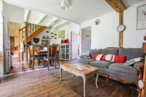 a living room with a couch and a table at Gîtes de Gueynard in Gauriaguet