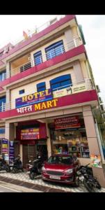 a red car parked in front of a building at Guest inn bharat mart in Haldwāni +8 photos