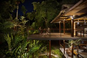 a house with a deck at night at Tilar Siro Andamans - A CGH Earth Experience in Havelock Island +175 photos