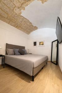 a bedroom with a bed with a stone ceiling at Bari LandLord 31- Old Town Apartment in Bari