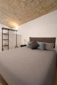 a bedroom with a large bed with a wooden ceiling at Bari LandLord 31- Old Town Apartment in Bari