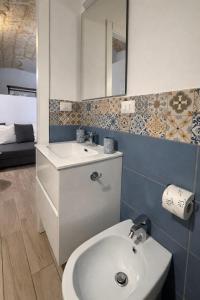 a bathroom with a sink and a mirror at Bari LandLord 31- Old Town Apartment in Bari
