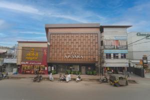 a group of buildings on a street in a city at Hotel Apsara in Kizhake Chālakudi