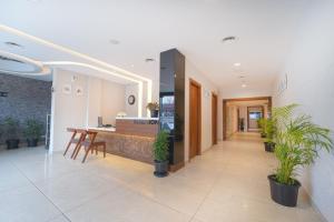 a hallway with plants and a counter in a building at Hotel Apsara in Kizhake Chālakudi