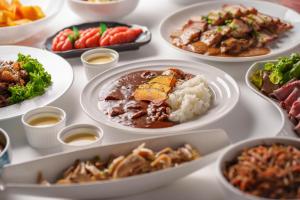 a table full of plates of food with different foods at Premier Hotel -CABIN- Obihiro in Obihiro