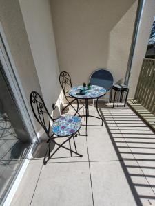 a patio with two chairs and a table on a balcony at Cozy Home in Roussillon en Isere