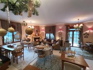 a living room with tables and chairs at To Kallion in Karpenisi