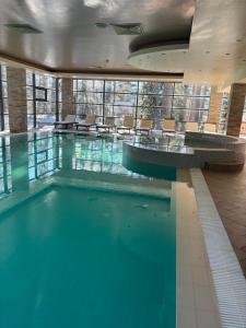 a swimming pool with blue water in a building at Chamkoria Forest apartment in Borovets