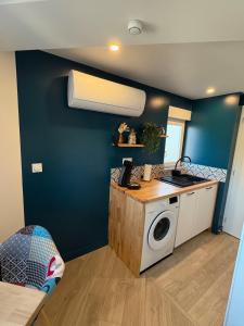 a kitchen with a washing machine in a room at Studio cosy avec balcon in Dunkerque