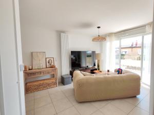 a living room with a couch and a tv at Cozy Home in Roussillon en Isere +26 photos