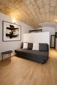 a couch in a room with a wooden floor at Bari LandLord 31- Old Town Apartment in Bari