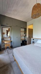a bedroom with a large white bed and a desk at Feli Eski Datca Adult Only in Datca