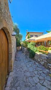 a stone walkway next to a stone wall at Feli Eski Datca Adult Only in Datca +87 photos