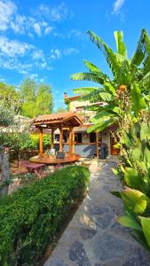a house with a pavilion in a garden at Feli Eski Datca Adult Only in Datca