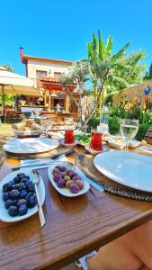 a wooden table with plates of food on it at Feli Eski Datca Adult Only in Datca