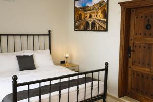 a bedroom with a bed and a picture on the wall at The Castle İnn in Mardin