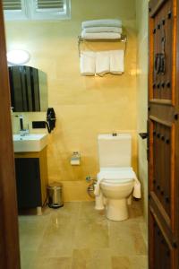 a bathroom with a white toilet and a sink at The Castle İnn in Mardin
