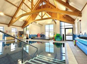 a swimming pool in a building with a pool at Sunset Seeker Morecambe in Morecambe