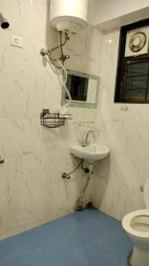 a bathroom with a sink and a toilet at RKS Homestay Anex in Shillong