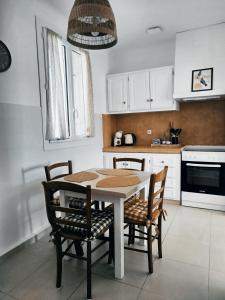 a kitchen with a table and chairs in a kitchen at La maison Françine in Sénas