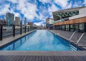a swimming pool on the roof of a building at Harbour Haven Sleep 7 Free Parking Free Tram to CBD in Melbourne