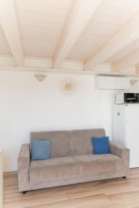 a couch in a living room with blue pillows at Villa AMARE in Caorle +31 photos