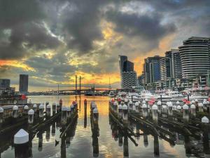 a group of boats docked in a harbor with a city at Harbour Haven Sleep 7 Free Parking Free Tram to CBD in Melbourne